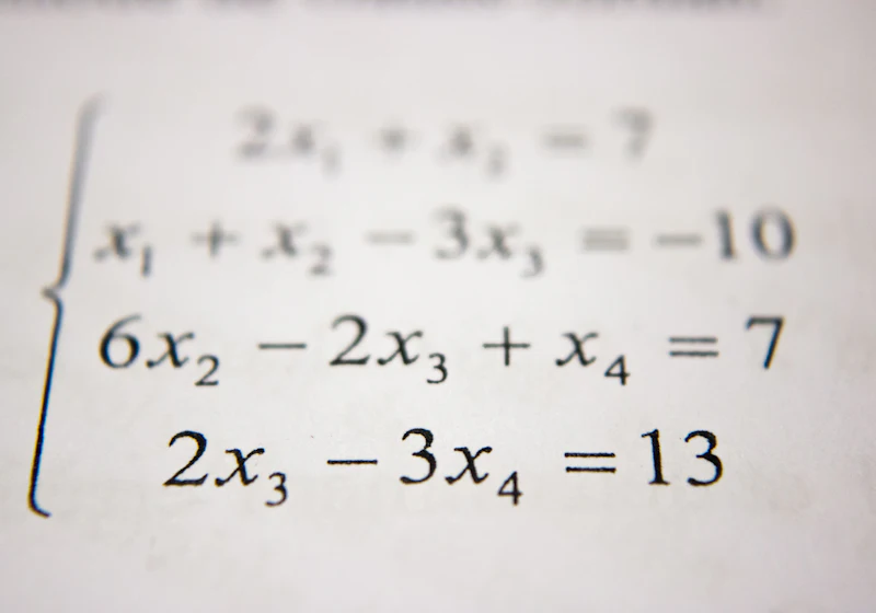 Chalkboard covered in mathematical diagrams and equations