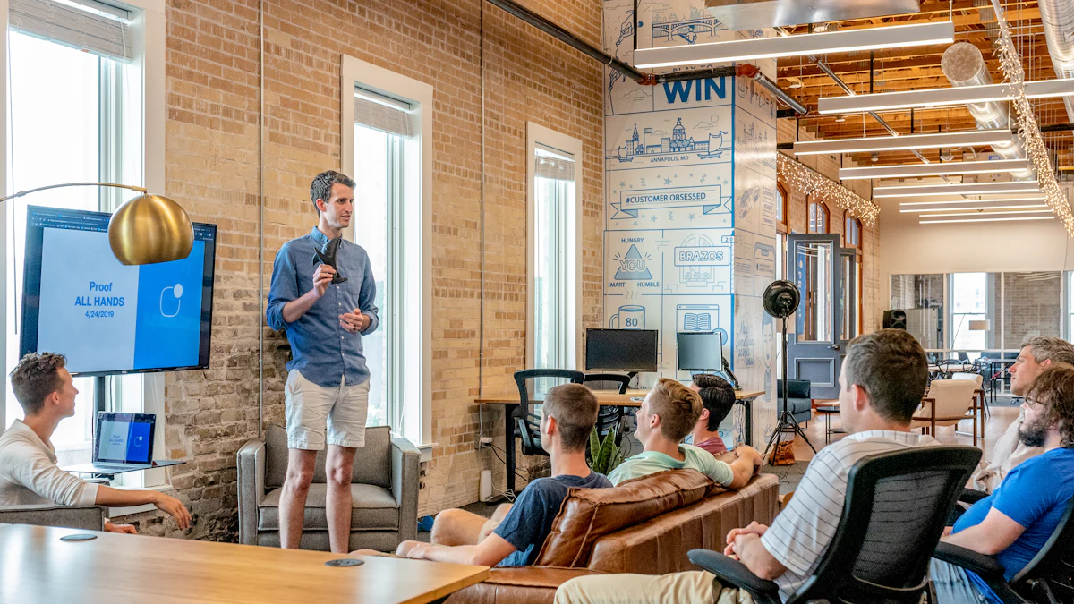 Colleague presenting to a seated team in a bright loft office