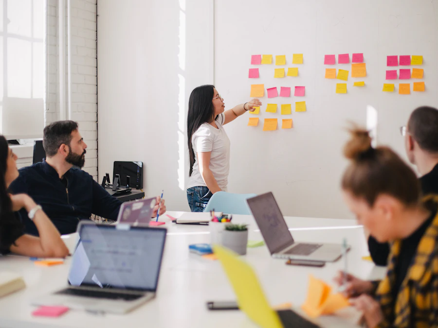 Researcher arranging sticky notes on a wall during a team session